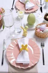 Festive table setting with napkin ring in shape of bunny ears, closeup. Easter celebration