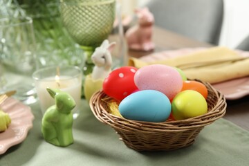 Fototapeta na wymiar Festive Easter table setting with painted eggs, closeup