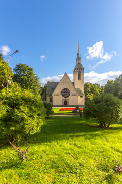 Famous Evangelical Lutheran Church of Transfiguration of Lord in Zelenogorsk. Green alley with grass and Square of Victory. Old Finnish city Terijoki now part of St. Petersburg city, Russia, Europe