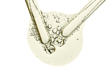 Two pipettes and a drop of cosmetic serum for the skin. Liquid body care product. Macrophotography....