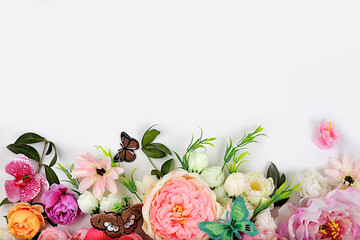 Beautiful flowers and butterflies on a light background.Abstract floral composition, still life, spring background or banner, holiday concept. Card for Mother's Day, Women's Day, Happy Birthday, 
