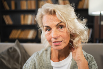 Fototapeta na wymiar Portrait of confident stylish European middle aged senior woman. Older mature 60s lady smiling at home. Happy attractive senior female looking camera close up face headshot portrait. Happy people