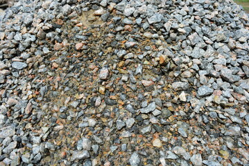 Building materials and fettling background, light crushed stone after rain.