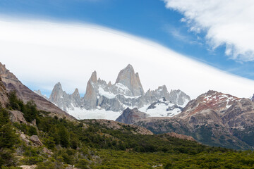 Mountain range Fitz Roy on a sunny day with blue sky and cool clouds. It is a mountain in Patagonia, on the border between Argentina and Chile
