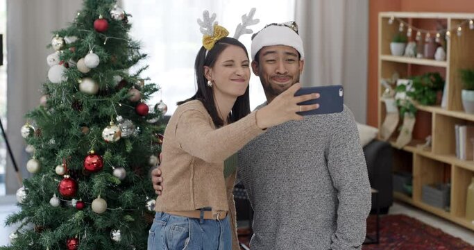 Funny, selfie and couple on Christmas in home with memory on social media, app or crazy celebration. People, smile and silly profile picture on phone, internet or post online to blog or website