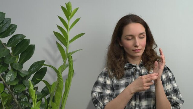 Person practicing EFT. Female tapping side of the hand, karate chop (KC) meridian point. 