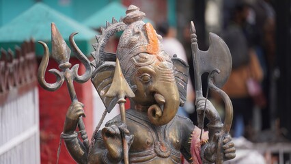 statue of lord ganesha holding weapons