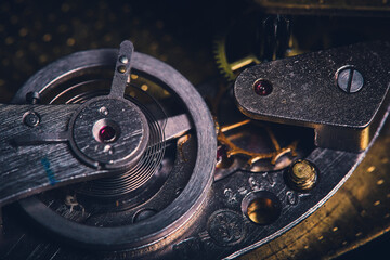 Macro view of gears in an old wall clock mechanism.