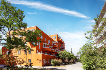Residential area with ecological and sustainable green residential buildings, low-energy houses with apartments and green courtyard - obrazy, fototapety, plakaty