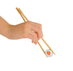 Hand with chopsticks eating maki roll, sushi with rice and salmon, isolated on white