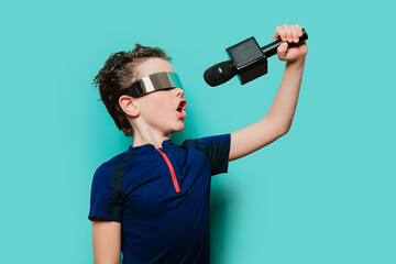 An energetic boy in a futuristic visor and sporty top belts out a tune, poised as if on stage against a teal background