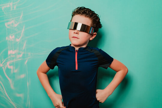 A young boy exudes confidence with his hands on his hips, wearing a high-tech visor, ready to enjoy a kids party