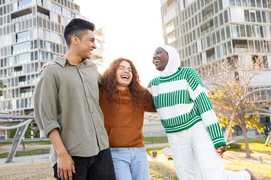 Multicultural students laughing together outdoors