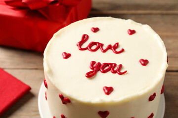 Bento cake with text Love You on wooden table, closeup. St. Valentine's day surprise