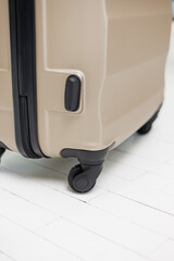 Golden suitcases with wheels isolated on white background. Suitcase for things. A suitcase for a tourist