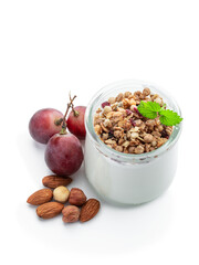Fresh natural homemade organic yogurt with granola and grapes in a glass jar isolated on white