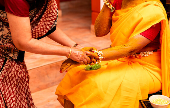 Haldi ceremony is an Indian pre-wedding ritual where turmeric paste is smeared on the bride's body by family and friends
