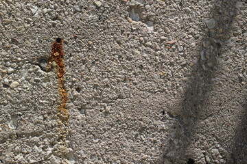 A full frame view of an old industrial concrete wall.