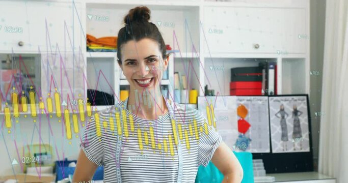 Animation of graph processing data over happy caucasian female fashion designer at studio