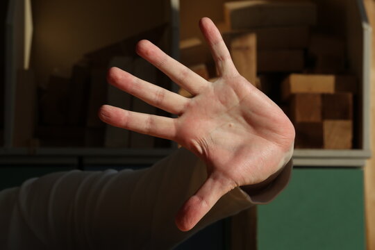 Palm of a young man hand on a dark background. Photo was taken 10 February 2024 year, msk time.