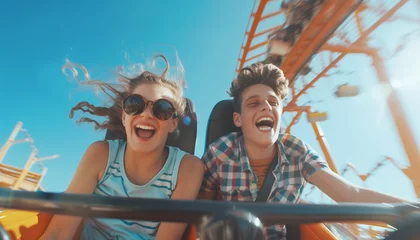 Gordijnen Portraits of two teenagers couple in love or brother and sister emotional screaming and laughing moment while they enjoying Roller coaster Funny time attraction ride on city carnival entertainment. © Train arrival