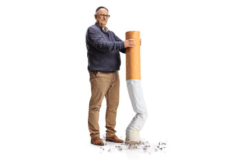 Full length portrait of a grumpy mature man putting off a big cigarette
