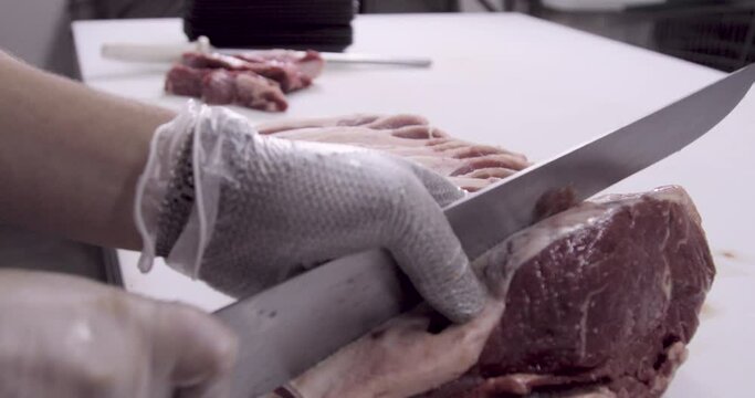slicing beef inside the butcher shop