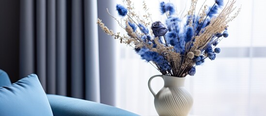 A vintage table displays a vase filled with vibrant blue flowers. The contrast of the blue petals against the rustic table adds a pop of color to the room.