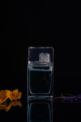 perfume bottle on a black background flowers spring aroma