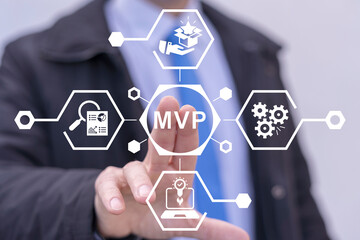 Businessman using virtual touch screen presses abbreviation: MVP. Minimum Viable Product ( MVP )...