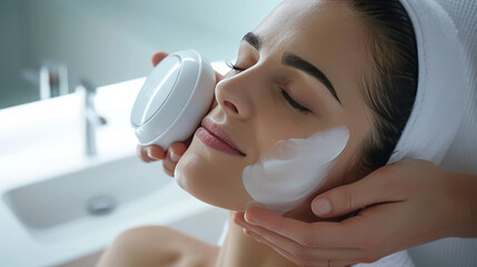 A woman does a facial massage with a special device