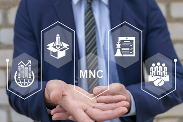 Businessman using virtual interface sees abbreviation: MNC. Multinational Corporation (MNC)...