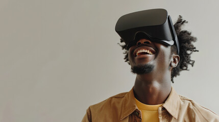A cheerful young man enjoys a VR experience, smiling against a plain background, to represent the technology's widespread appeal, its use in leisure and entertainment