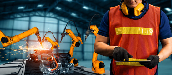 XAI Engineer use advanced robotic software to control industry robot arm in factory. Automation...
