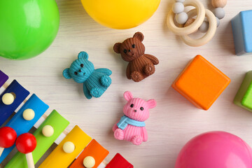Obraz premium Baby song concept. Wooden xylophone and toys on table, flat lay