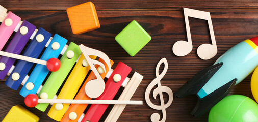 Baby song concept. Wooden notes, xylophone and toys on table, flat lay