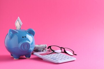 Financial savings. Piggy bank, dollar banknotes, glasses and calculator on pink background - obrazy, fototapety, plakaty