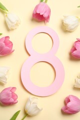 8 March greeting card design with beautiful tulips on light yellow background, flat lay