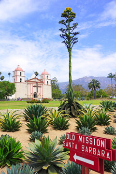Landscape of Queen of Spanish Missions, Old Mission Santa Barbara, in California, with aloe plants in foreground.
