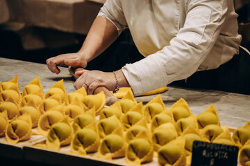 The chef prepares the cappellacci with ricotta and spinach