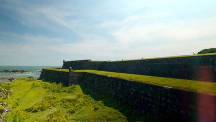 Fort's exterior wall in Kinsale, Ireland. Action. Stone fortress and the sea shore.