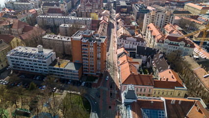 Obraz premium Drone footage from downtown of Szeged, Hungary on a sunny winter day. Szeged, Drone, Aerial, Hungary, Urban Landscape, Szeged Cathedral, Tisza River, Bridge
