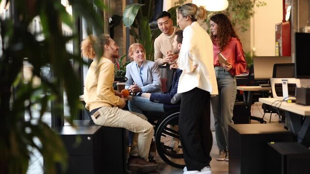 group of men and women in coworking inform talking all together