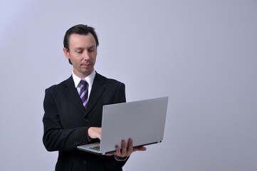 homem de negócios vestido para o comércio  segurando computador portatil , negócios online 