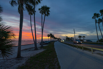 Sunset. Colorful sky after sunset. Causeway Blvd, Dunedin Florida. Honeymoon Island Florida. Park closes at dusk. The road goes into the horizon. Gulf of Mexico. Summer or spring vacation in Florida