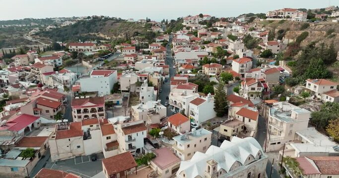Aerial view Pissouri village Cyprus. Urban landscape with buildings in the mountains, streets of historical architecture and nature. High quality 4k footage