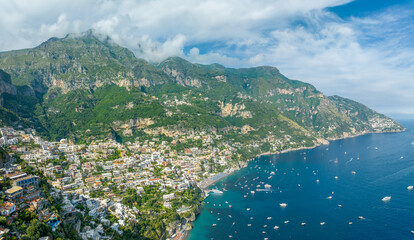 Positano iconic cliffside village cascades to the Amalfi Coast azure waters, epitomizing the...