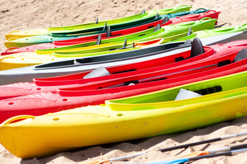 multi-colored canoes on the sand 
