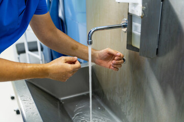Operating preparation concept. Surgery specialist washing hands for sterile work.