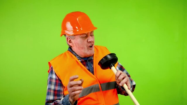 Funny plumber imitating singing with plunger.